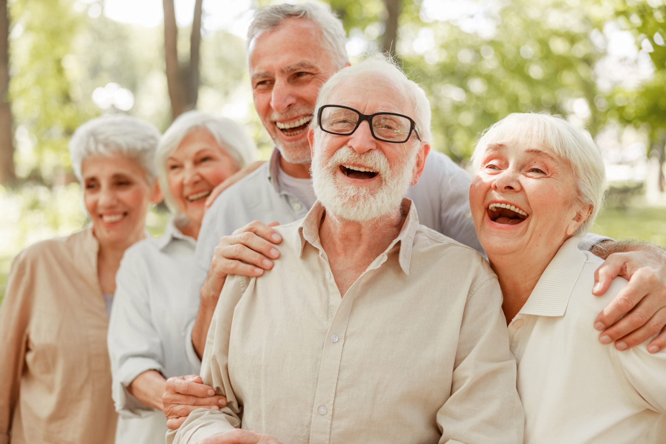 Cheerful old people standing on the street; Laughing senior people spending time outdoors